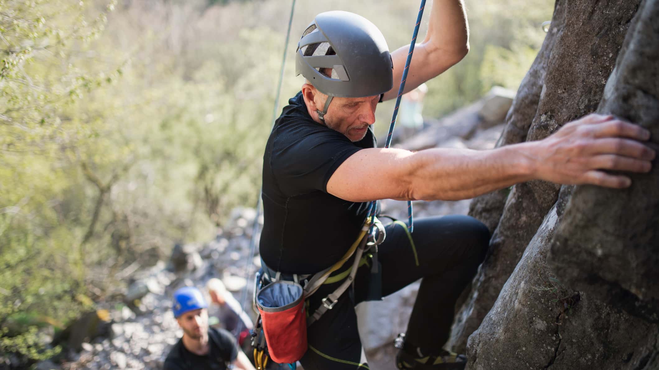 Older climber on a route, climbing for life