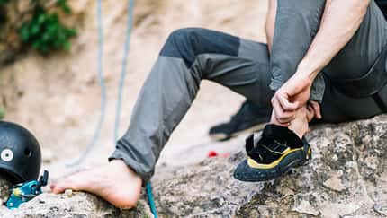 Man wearing boot before going for rock climbing