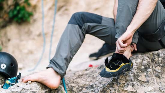 Man wearing boot before going for rock climbing
